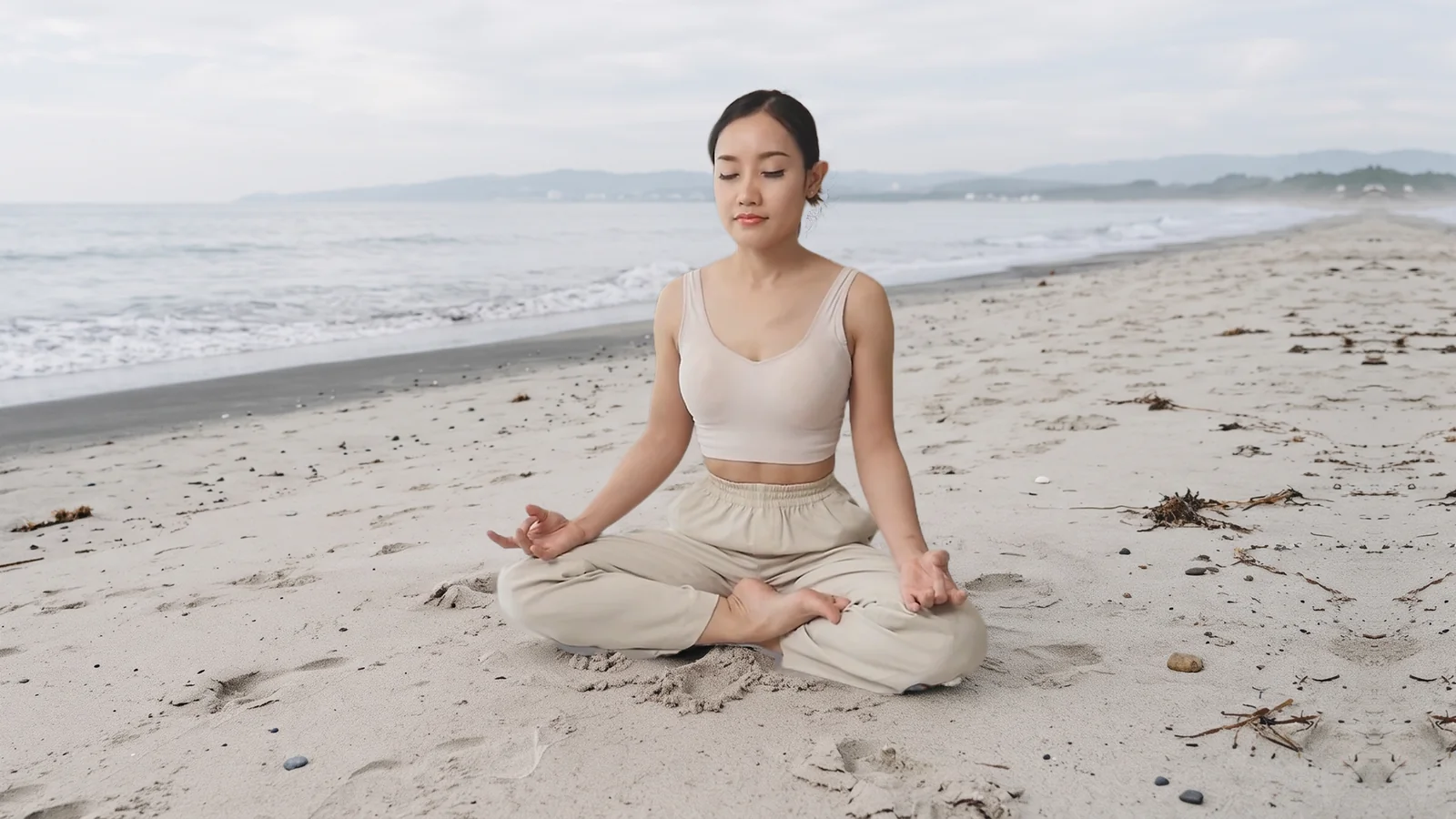 Marketing composite of a woman sitting on a beach after background replacement