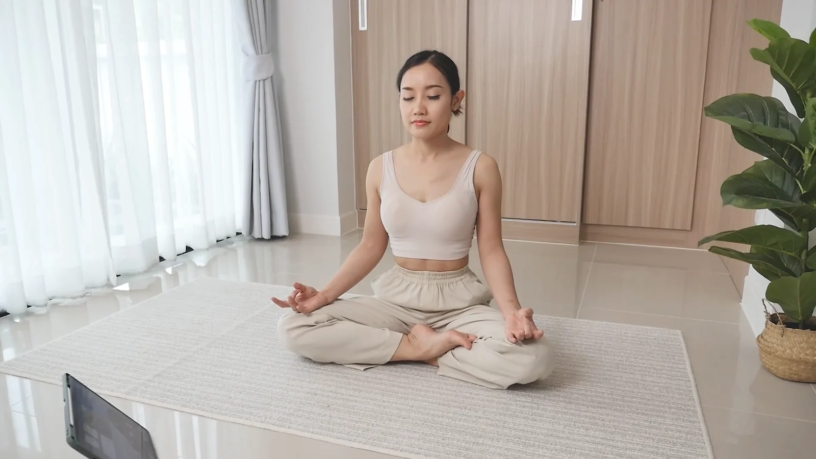 Original indoor scene with the same woman sitting in an apartment